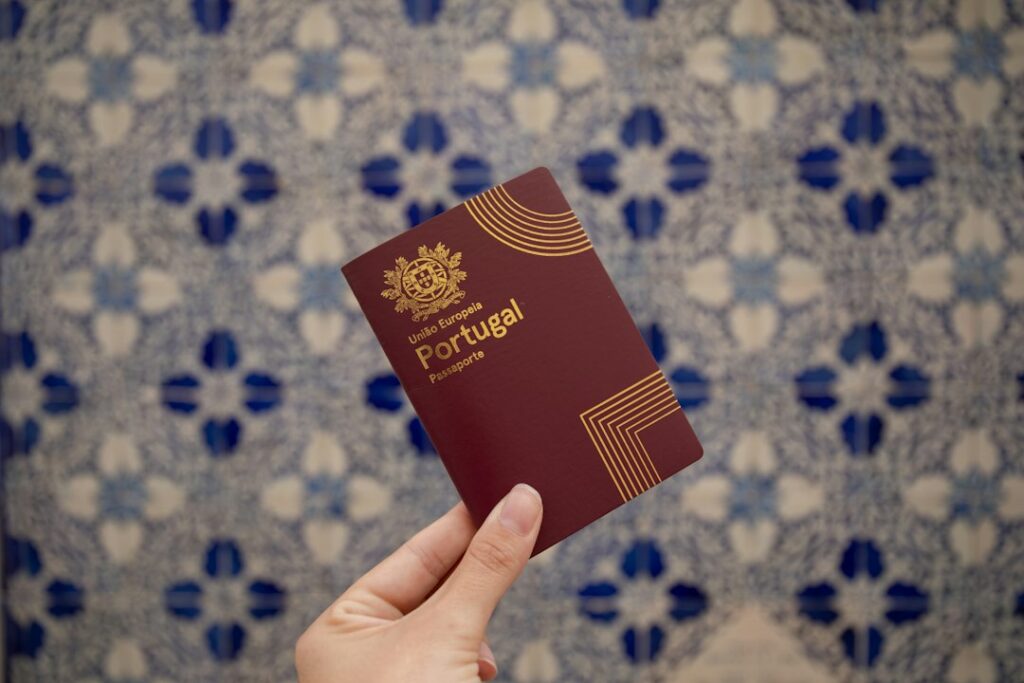 A hand holding a Portuguese passport